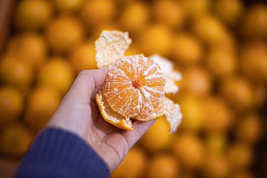 Tangerines or mandarines and slices in bamboo bowl on wooden board copy space