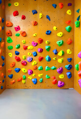 Fototapeta premium Indoor rock climbing wall with colorful holds, fitness and adventure sport, active lifestyle and challenge
