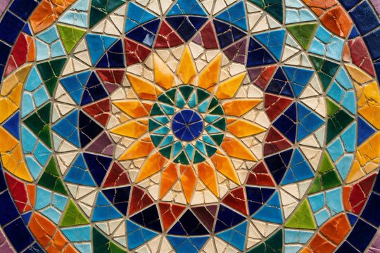 Mosaic tiles forming radial geometric pattern on surface