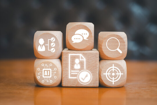 Visual representation of AI-driven talent acquisition using digital icons on wooden blocks, symbolizing modern recruitment strategies.
