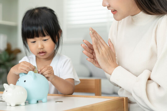 Child happy lean Save money. Mother teaching daughter for saving. wealth, Finance, insurance, investment, education, future, plan life, banking, family, health, health and accident insurance.