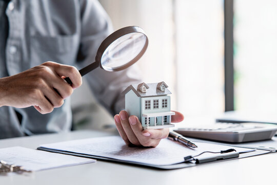 financial advisor evaluates house valuation and mortgage loan in an office
