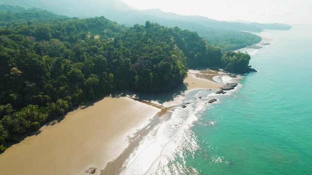 Remote tropical bay with lush dense rainforest on Pacific coast in Costa Rica