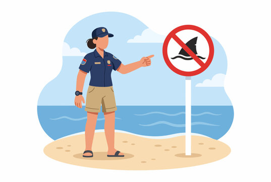 Lifeguard pointing to shark warning sign on beach for safety
