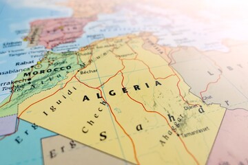 Fototapeta premium Map of Algeria with flare from top right corner. Selective focus on label, close-up view