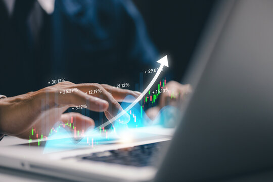 Business person using laptop with rising financial chart and upward arrow, representing investment growth, stock market performance, profit increase, trading analytics and economic success.