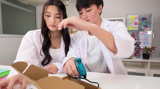 Thai Students Using Glue Gun for Science Project in Bangkok Classroom