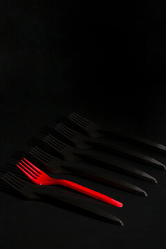 Still life with red and black forks