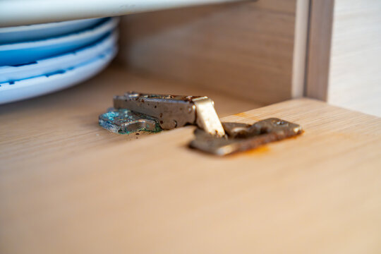 Corroded cabinet hinge inside a sailing yacht exposed to saltwater environment. Marine corrosion highlighting maintenance challenges and long term boat ownership.