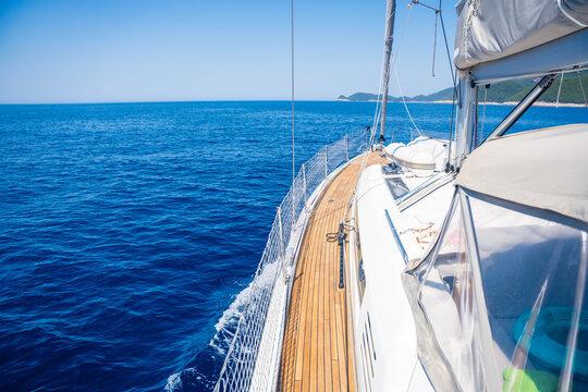View from the deck of a modern sailing yacht cruising along the Adriatic Sea coast in Croatia. Luxury sailing travel and freedom at sea concept.