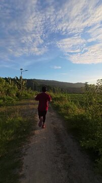 Person Running on a Dirt Path at Sunset