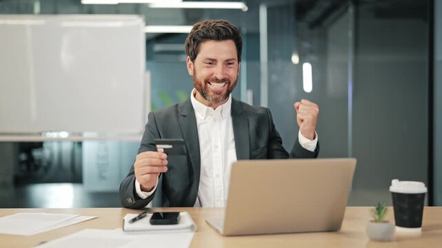 Business professional completes online payment, experiencing success. Satisfaction after processing digital transaction with credit card and laptop. E-commerce victory.