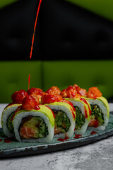 Pouring spicy sauce over avocado sushi rolls © Cavan