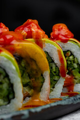 Delicious sushi rolls drizzled with spicy sauce © Cavan