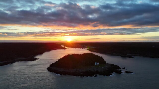 Stunning aerial view of a coastal lighthouse at sunrise