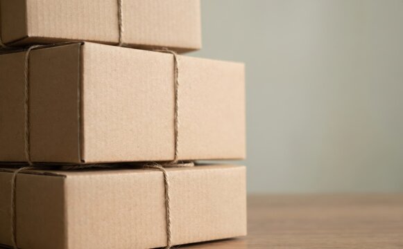 Stacked cardboard boxes tied with string representing shipping delivery and e-commerce packaging concepts