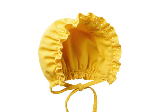 Sunny yellow baby bonnet with delicate eyelet ruffle and tie closure isolated white background