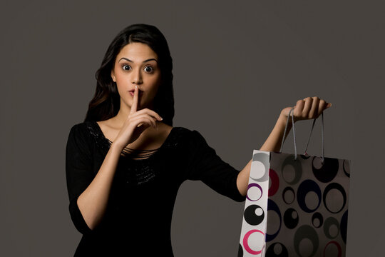 Girl with a gift bag giving a surprise 