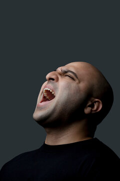 Bald man screaming 