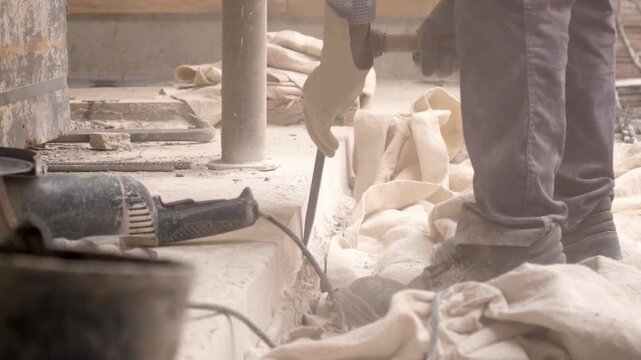 Worker Breaking Cement with Manual Sledgehammer and Cold chisel Tools