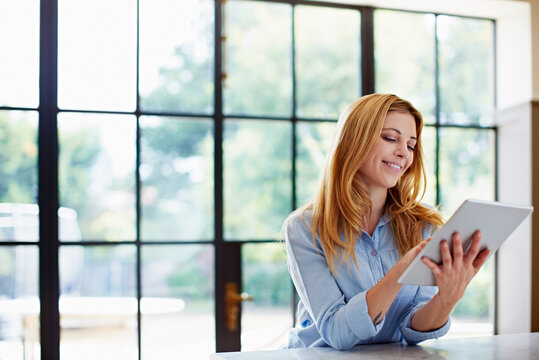 Smile, woman and relax at house with tablet, social media and browsing online for latest movies. Female person, rest and reading in home with digital, internet search and streaming for film watchlist