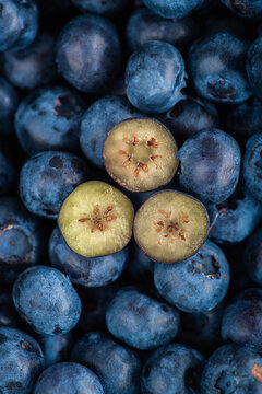 Fresh blueberries with one cut berry macro close up. Top view.