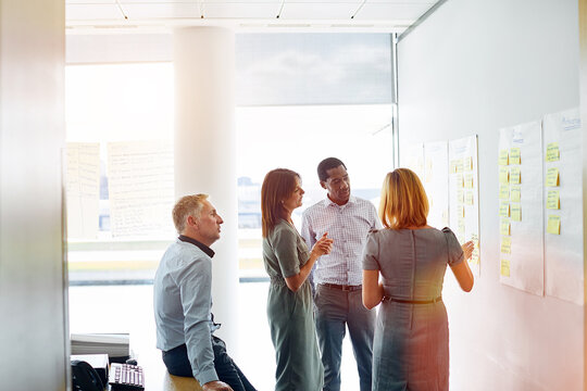 Meeting, sticky note or team in office with brainstorming, cost reduction or risk mapping for audit. Finance staff, people or strategy for scenario planning, compliance preparation or budget timeline