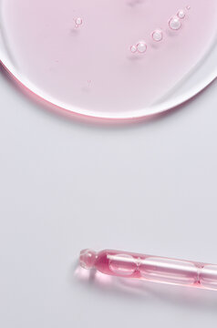 Pink cosmetic product for skin care. A serum or body gel or a moisturizer. Copy space