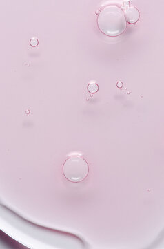 Pink cosmetic product for skin care. A serum or body gel or a moisturizer.