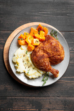 Autumn meal: chicken quarter with glazed pumpkin and mashed potato