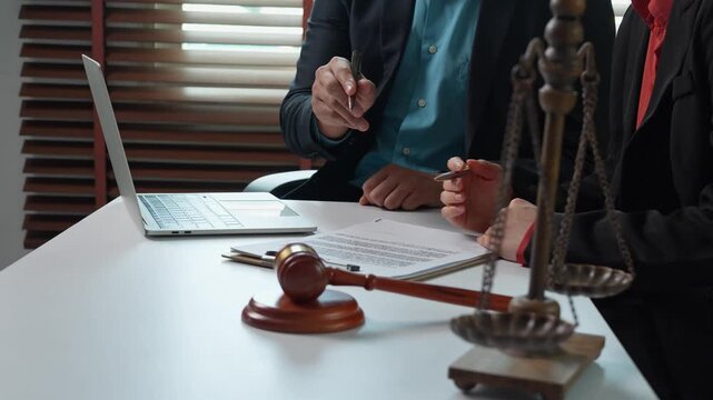Lawyer advising client and signing legal document