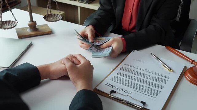 Corrupt lawyer counting bribe money in office