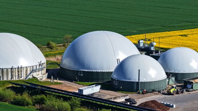 Biogas Digesters with Agricultural Machinery and Rapeseed Fields