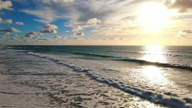 Coastal Serenity: Gentle waves caress the sandy shore under a vibrant sky as the sun descends, casting a golden hue across the tranquil ocean.
