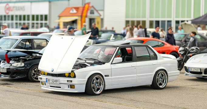 Kristiansand, Norway - June 14 2026: White BMW E30 display car with open hood at meet.