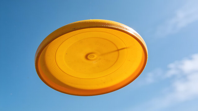 Bright Yellow Clay Shooting Target in Blue Sky