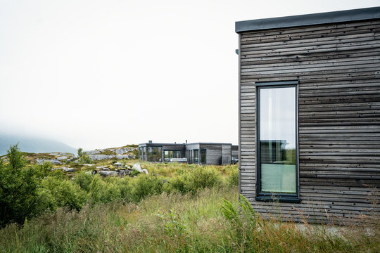 Contemporary cabin exterior in a wild green landscape