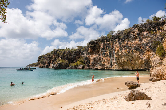 People enjoying a beautiful day at a secluded tropical cove