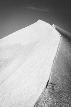 Mountaineers trekking along a snowy mountain ridgeline