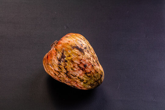 Ripe anona fruit with textured skin on dark background