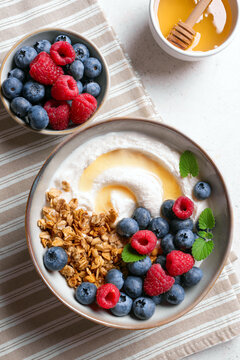 Granola bowl with greek yogurt, berries and honey for healthy breakfast.
