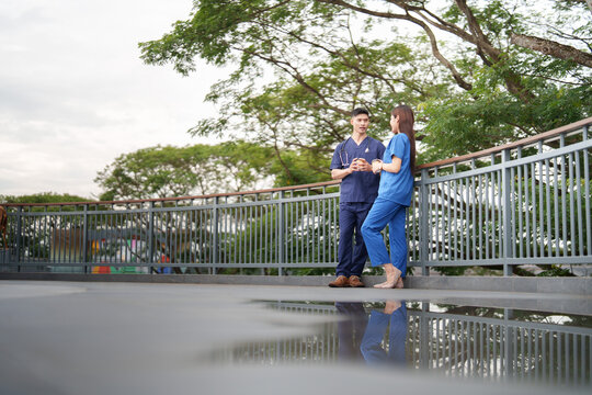 Healthcare workers on break time outdoors with water reflection