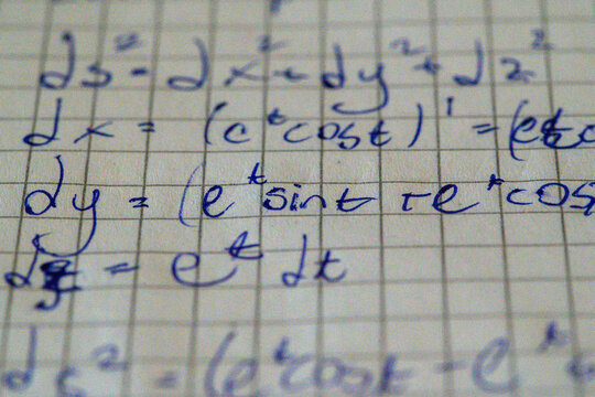 Extreme close-up math formula handwriting blue ink