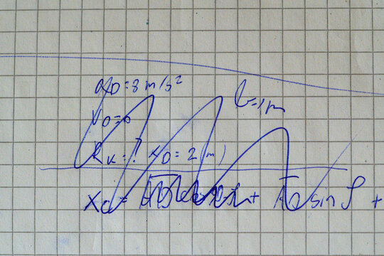 Handwritten kinematics problem with acceleration values