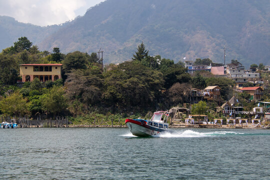 Speedboat on lake near mountain village