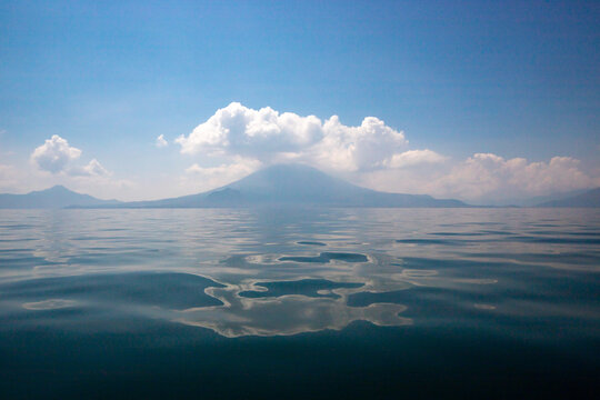 Calm lake with mountain and cloud reflections