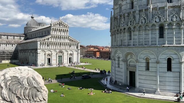 Piazza dei Miracoli in Pisa with the Baptistery of St. John, Cathedral and Leaning Tower under a blue sky, panoramic high angle view, Tuscany, Italy