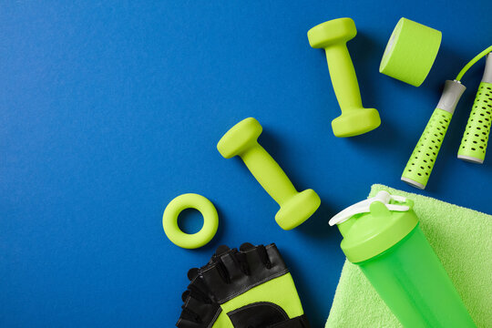 Fitness equipment layout with green accessories on blue background.