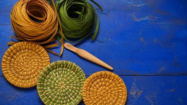 Assortment of woven natural baskets and coiled materials, rustic textures against a bright blue background, perfect for farmhouse decor, craft projects, or artisanal displays