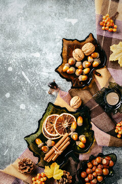 Autumn flat lay composition. Vertical border with cozy plaid, nuts and spices.